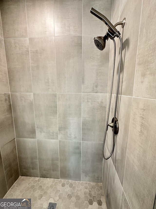 bathroom with tiled shower