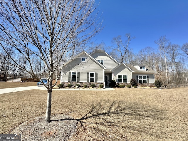 view of front of home featuring stone siding and fence