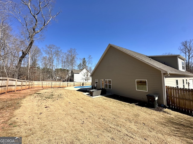 view of home's exterior with a patio area and a fenced backyard