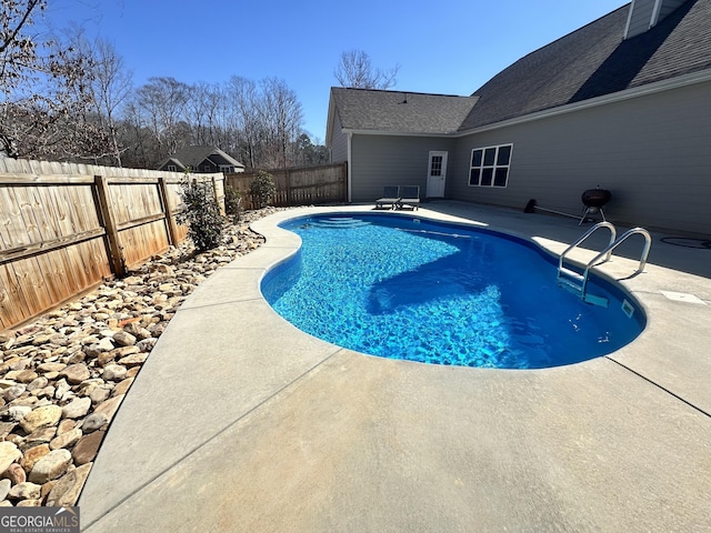 view of swimming pool with a fenced in pool, a patio area, and a fenced backyard