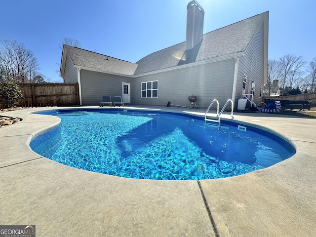 view of swimming pool with a patio area, fence, and a fenced in pool