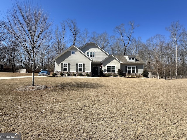 view of front of home with a front yard and stone siding