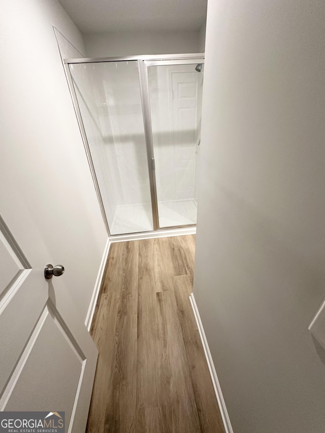 interior space with wood finished floors and baseboards