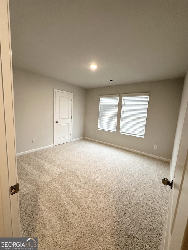 unfurnished room with recessed lighting, carpet, and baseboards