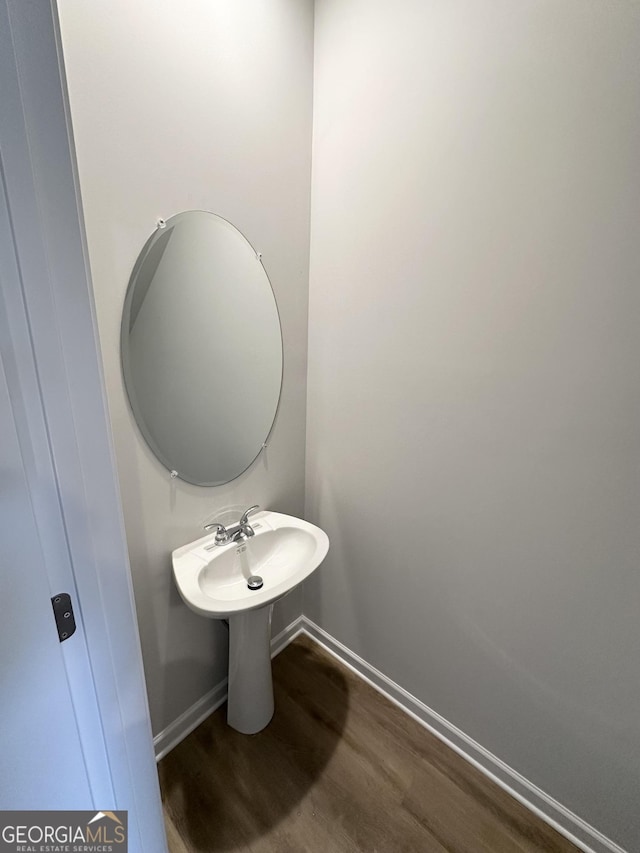 bathroom featuring wood finished floors and baseboards