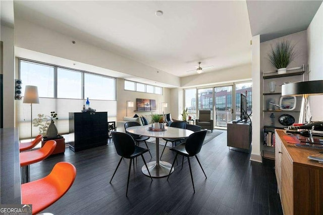 dining space featuring dark wood-style floors and ceiling fan