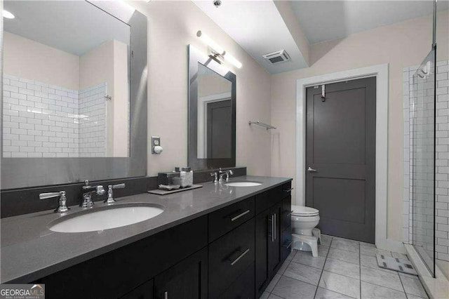 bathroom with double vanity, a sink, visible vents, and a shower stall