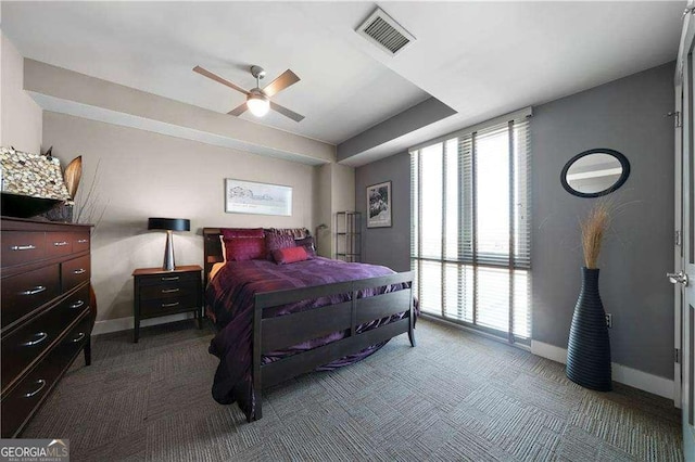 bedroom featuring a ceiling fan, baseboards, visible vents, and carpet flooring