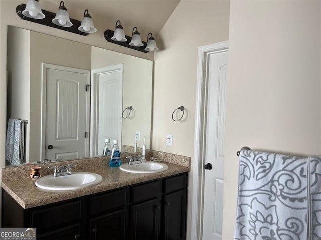 bathroom with a sink and double vanity