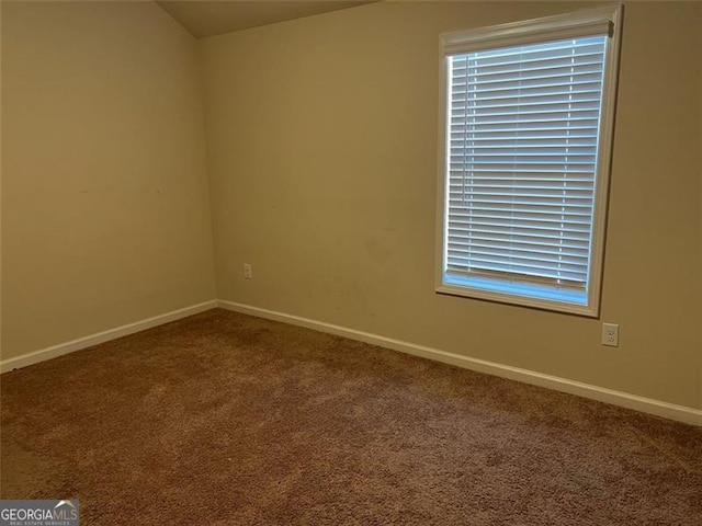 carpeted empty room with baseboards