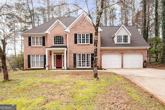 view of front facade featuring concrete driveway, brick siding, a front lawn, and an attached garage