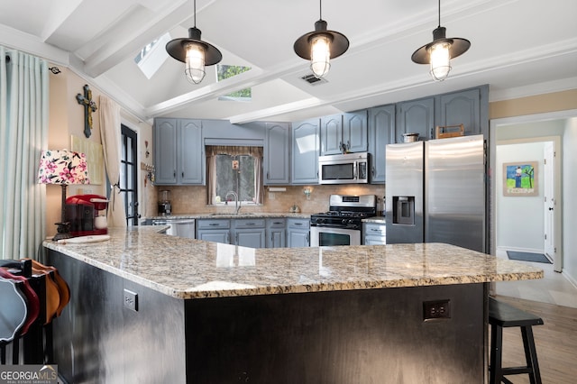 kitchen with light stone counters, a peninsula, visible vents, appliances with stainless steel finishes, and pendant lighting