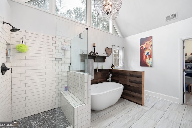 full bath featuring visible vents, an inviting chandelier, a freestanding tub, baseboards, and walk in shower