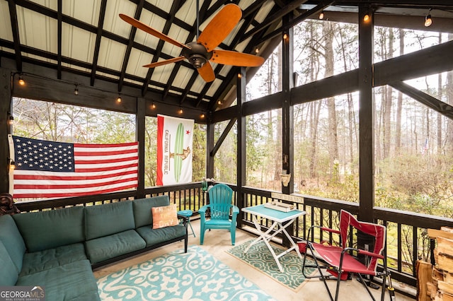 sunroom with ceiling fan and vaulted ceiling