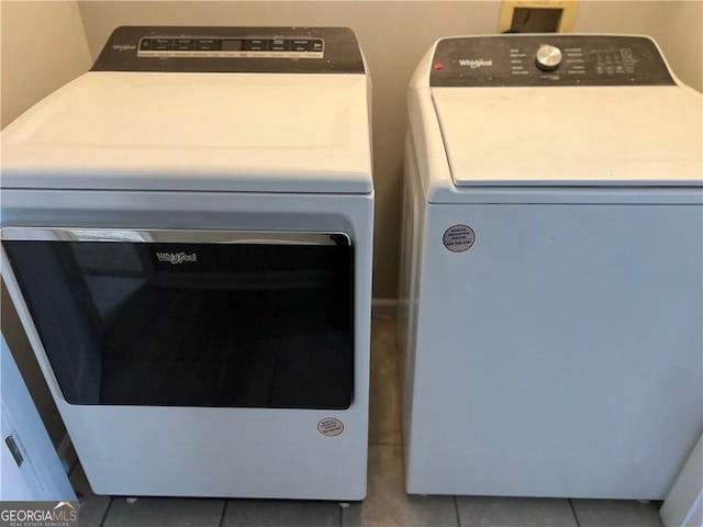 clothes washing area with tile patterned flooring, laundry area, and washing machine and clothes dryer