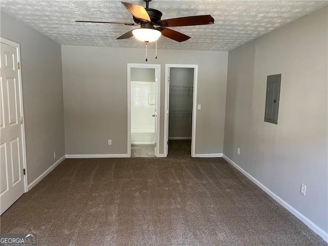 unfurnished bedroom featuring a textured ceiling, carpet flooring, electric panel, and baseboards