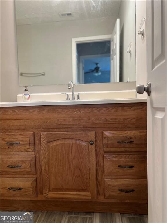 bathroom with visible vents and vanity