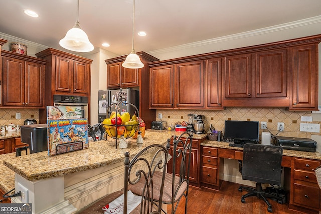 kitchen with stainless steel appliances, dark wood-type flooring, light stone countertops, built in desk, and crown molding