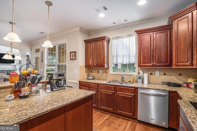 kitchen with visible vents, stainless steel dishwasher, crown molding, light wood-style floors, and a sink