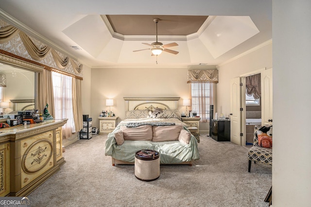 bedroom with crown molding, a raised ceiling, visible vents, carpet flooring, and ceiling fan