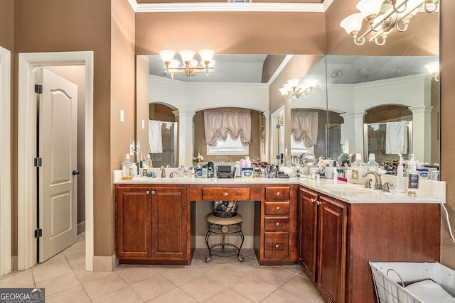 bathroom with a chandelier, crown molding, a sink, and double vanity