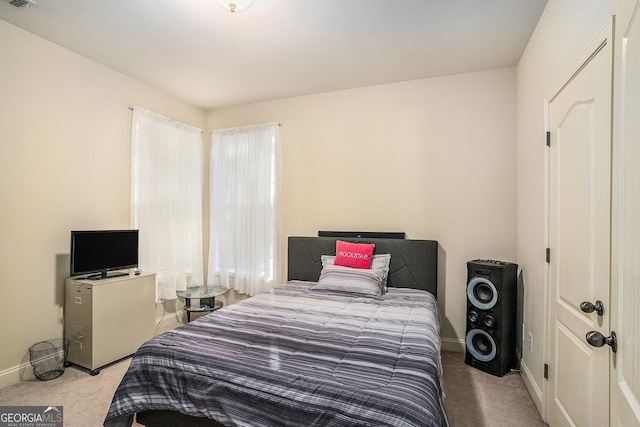 carpeted bedroom featuring visible vents and baseboards