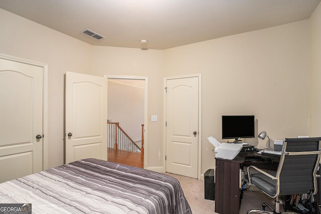 bedroom featuring light colored carpet and visible vents