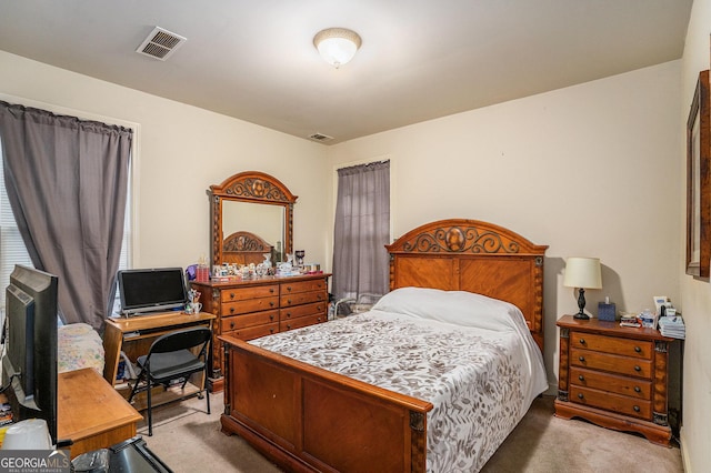 bedroom with visible vents and carpet flooring