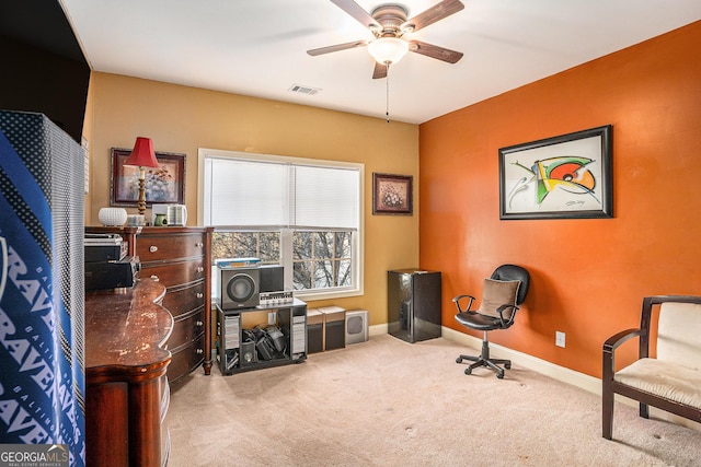 office space with carpet floors, baseboards, visible vents, and a ceiling fan