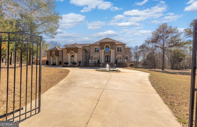 mediterranean / spanish-style home with concrete driveway