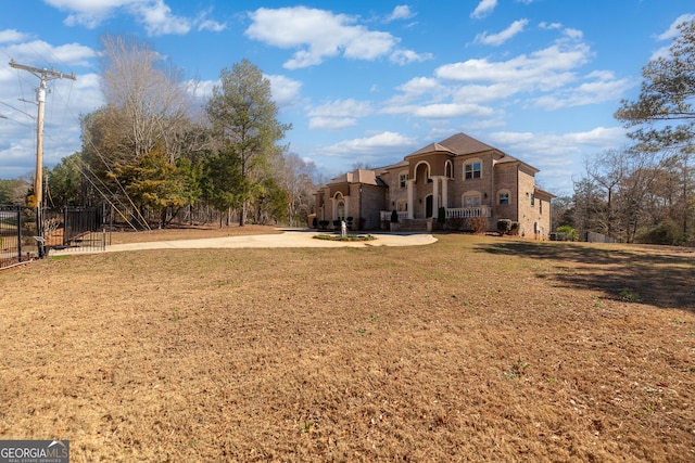 exterior space featuring a front lawn and fence