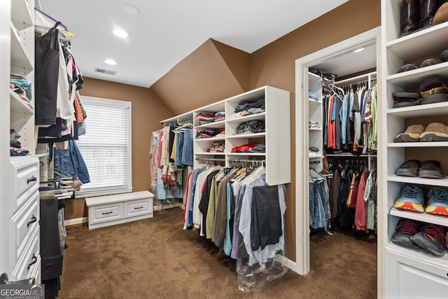 spacious closet with dark colored carpet and visible vents