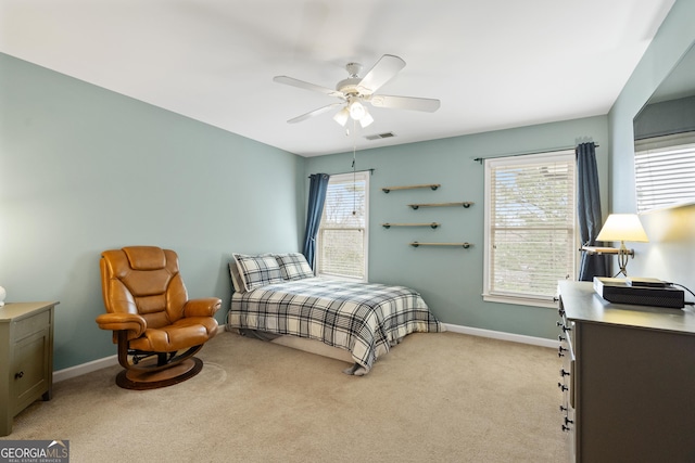 bedroom with light carpet, baseboards, multiple windows, and visible vents