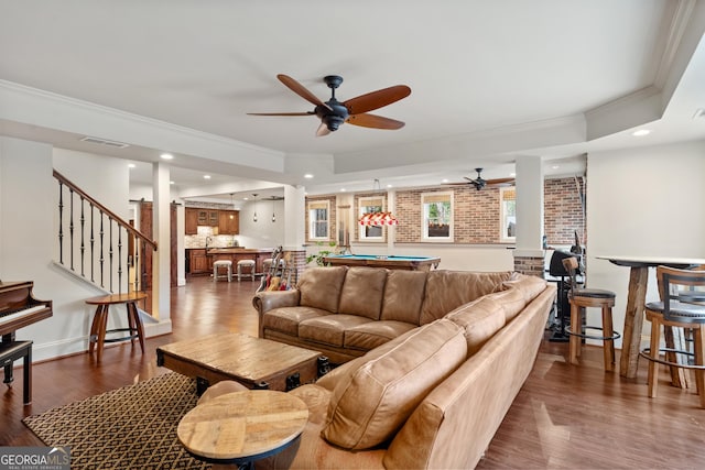 living room with dark wood-style floors, crown molding, visible vents, billiards, and stairs