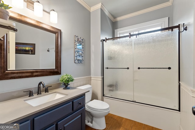 full bath with enclosed tub / shower combo, a wainscoted wall, wood finished floors, vanity, and ornamental molding