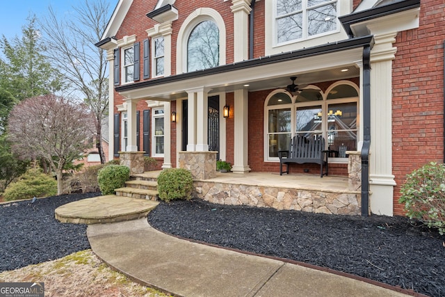 entrance to property featuring a porch and brick siding