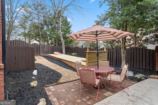 view of patio with outdoor dining space and a fenced backyard