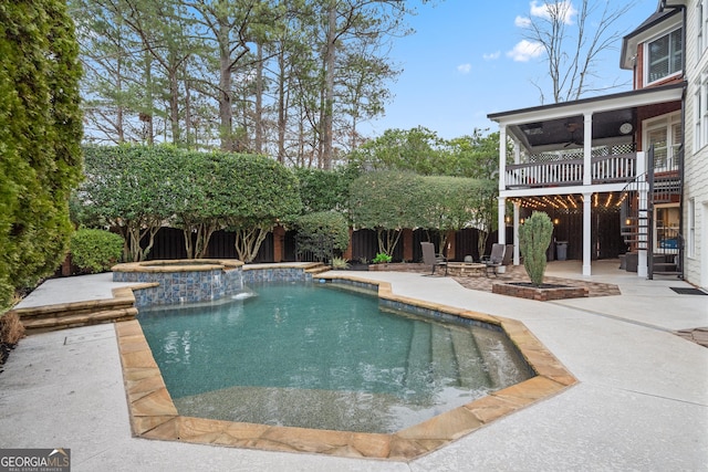 view of swimming pool featuring stairs, a patio, a fenced backyard, and a pool with connected hot tub