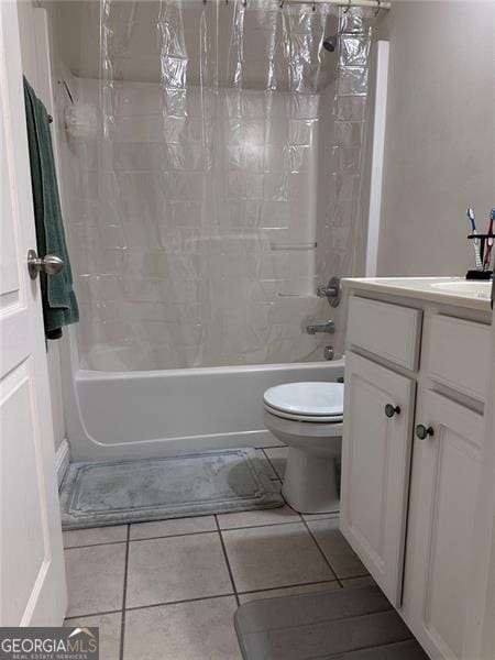 bathroom with vanity, tile patterned flooring, shower / bath combination with curtain, and toilet