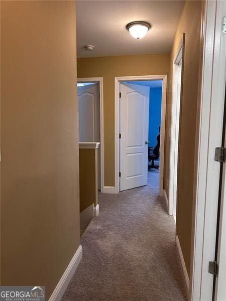 corridor with carpet and baseboards