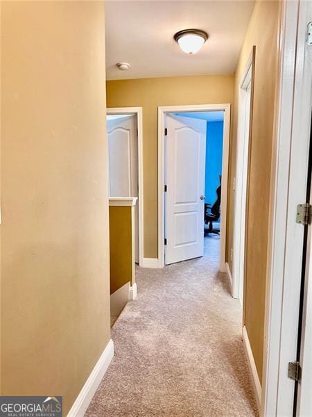 hall with light carpet and baseboards