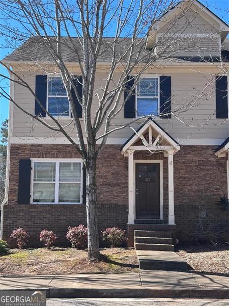 view of front of property with entry steps and brick siding