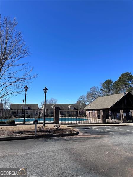 exterior space featuring fence and a community pool