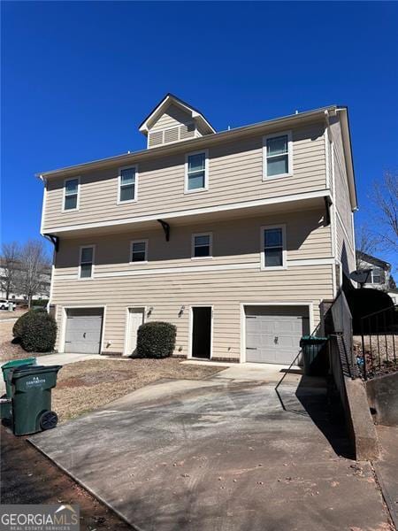 townhome / multi-family property featuring driveway and an attached garage