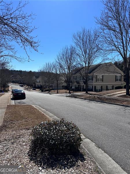 view of road featuring curbs, sidewalks, and a residential view