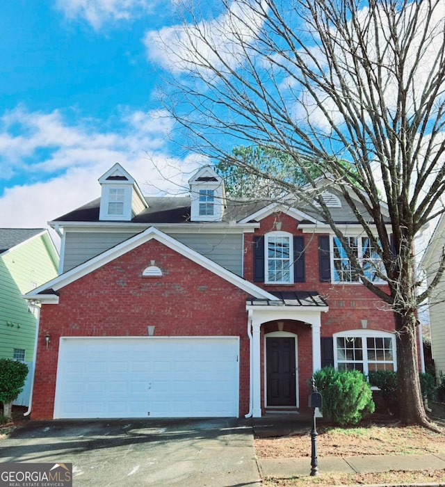 view of front of property with driveway, a garage, and brick siding