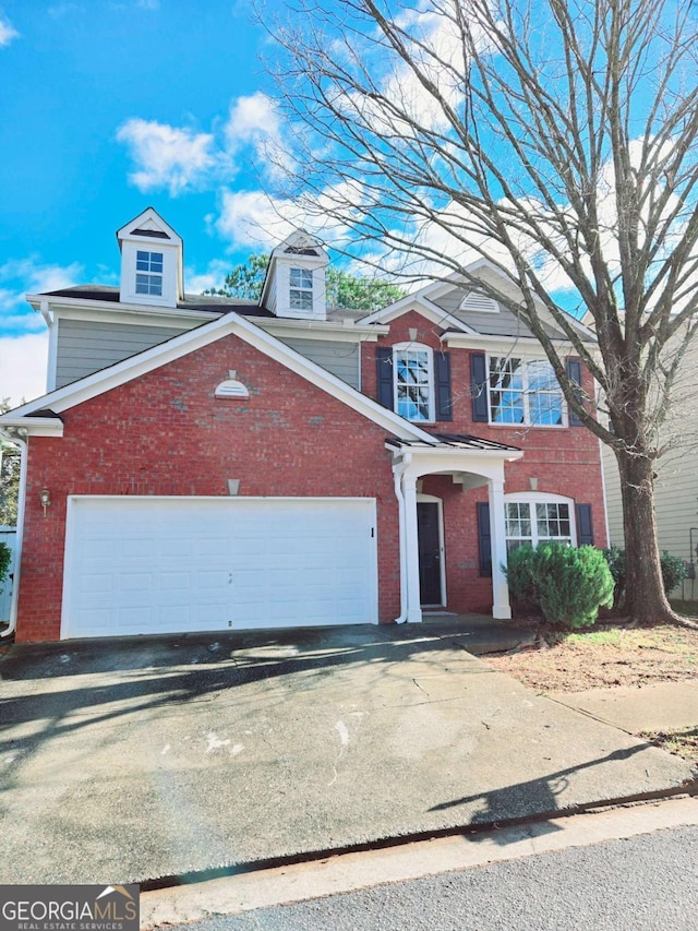 view of front of property with brick siding, driveway, and an attached garage