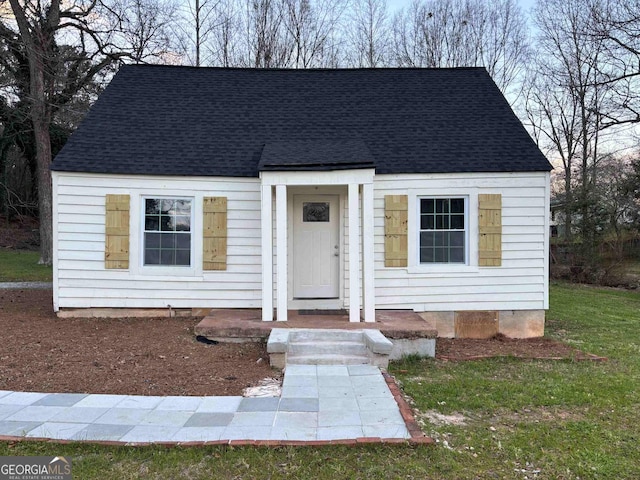 cape cod house featuring crawl space and roof with shingles