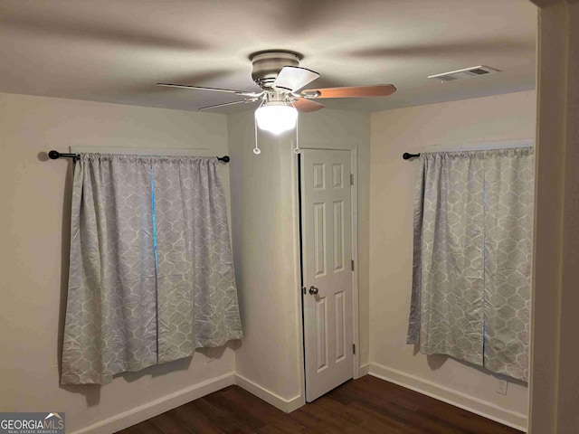 bathroom with a ceiling fan, baseboards, visible vents, and wood finished floors