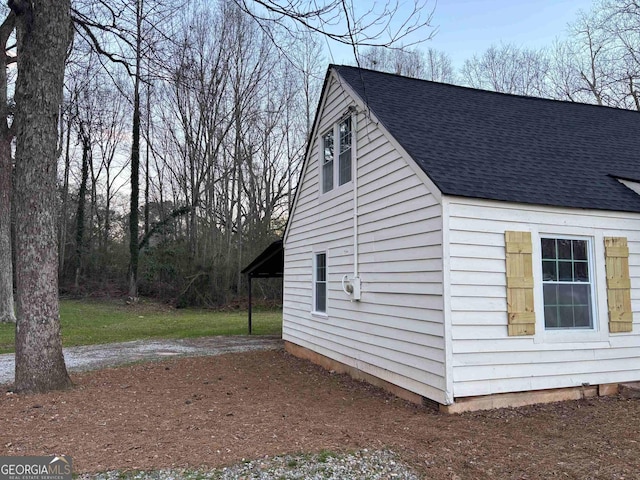 view of home's exterior with roof with shingles